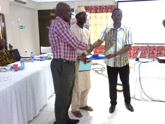  Mr Mohammed (right) presenting the document to Mr Musah. Looking on is Alhaji Fawei. Picture: Vincent Amenuveve  
