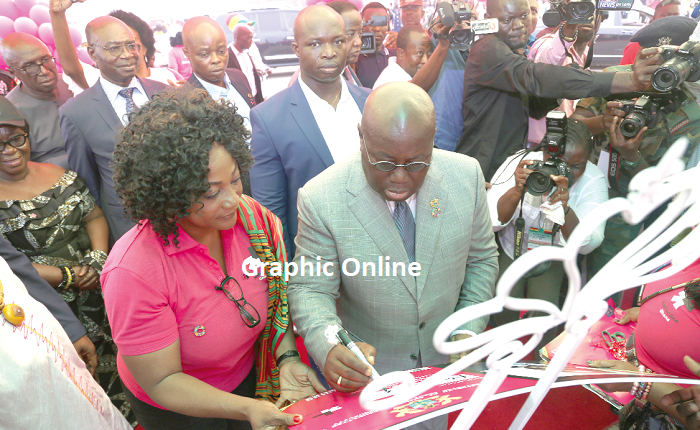 President Nana Addo Dankwa Akufo-Addo appending his signature to signify the launch of the HeForShe Project. On his right is Ms Otiko Afisah Djaba. Picture: SAMUEL TEI ADANO