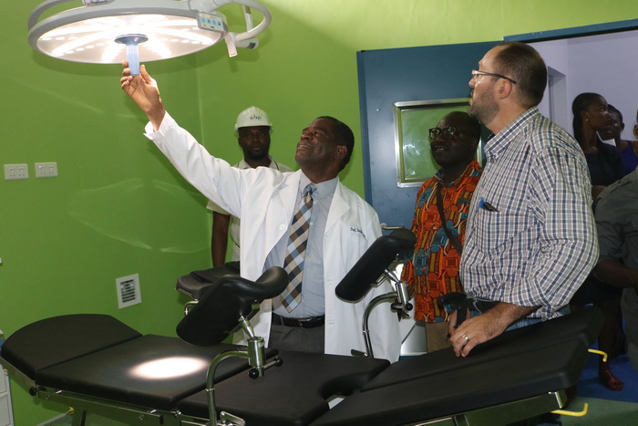 Professor Baffour Opoku (left) trying his hands on a light in one of the theatres. Looking on is Mr Stephen Coret 