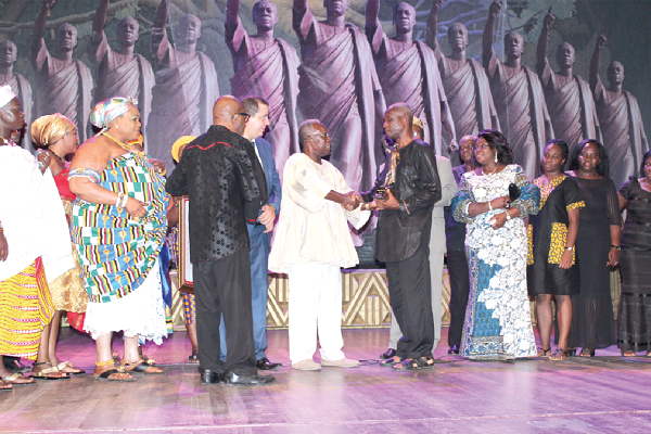  Mr Kojo Yankah (in smock) presenting the Posthumous Award to a family representative of Prof. Francis Kofi Ampenyin Allotey, while other members of the family look on.  Picture: NII MARTEY M. BOTCHWAY