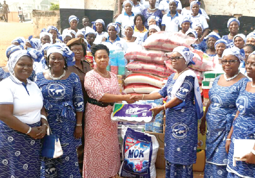 DSP Dora Annan (3rd left), Officer-in-charge of Religious Affairs of the Kumasi Female Central Prisons, receiving the items from Mrs Joana Badu Wood (4th right)