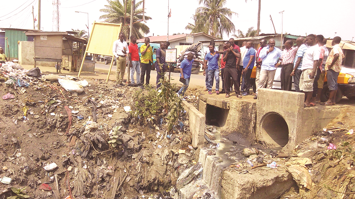 Mr Eben Nartey (2nd right) showing a drain to engineers from the Department of Urban Roads  PICTURE BY EMMANUEL QUAYE