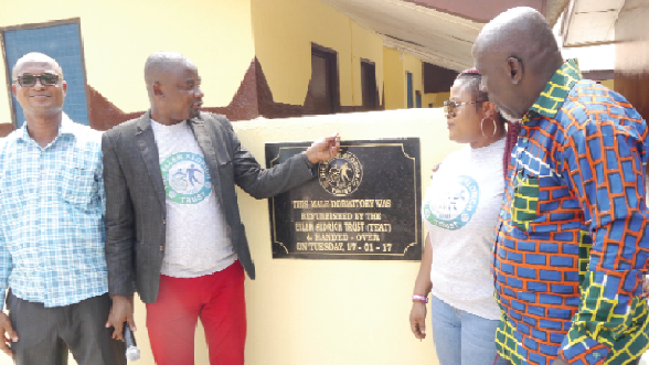 Mr Charles Osei Asibey (2nd left) being assisted by Mr Seth Appeagyei (left), Manager of the Home; Mrs Millicent Boaterg (2nd right), International Relation Director; and Mr Anthony Mensah (right), Board Chairman of the Socially Disadvantage Home, to unveil a plaque to open the renovated facility