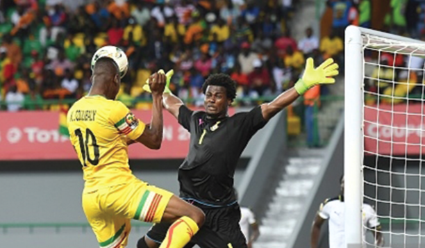  Ghana's goalkeeper Braimah Razak boldly blocking a shot at goal from  Mali's Kalifa Coulibaly