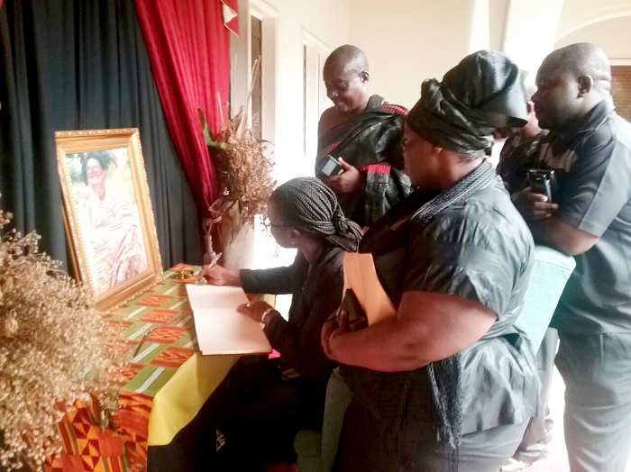 The National President of PPAG, Prof. Rita Akosua Dickson, signing the book of condolence after paying a courtesy call on the Asantehene, Otumfuo Osei Tutu II, at the Manhyia Palace as other members of the PPAG look on