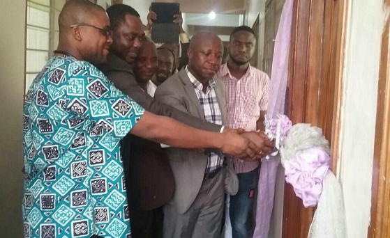 Dr Kwadwo Gyebi Agyenim Boateng (left), the Medical Director of Hart Advertist Hospital, being assisted by some dignitaries to cut the tape to inaugurate the Dialysis Centre at Ahinsan