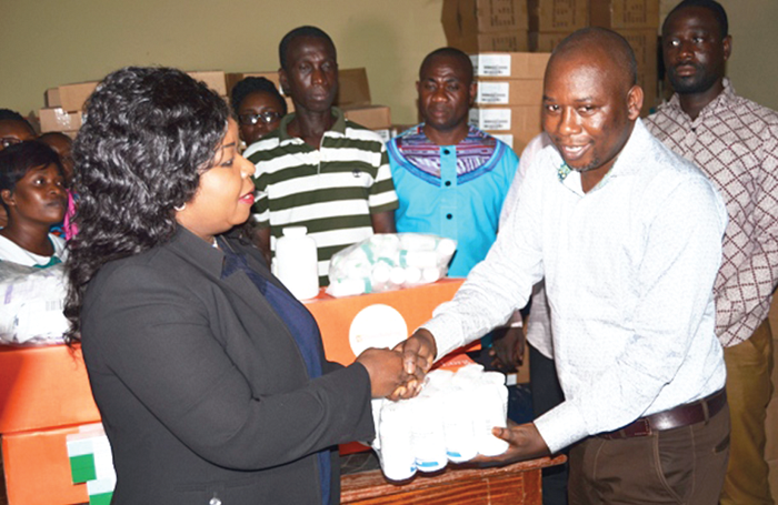  Dr Wiafe Addai presenting some of the drugs to Mr Emmanuel Bortey, a pharmacist at the Accra Psychiatric Hospital.