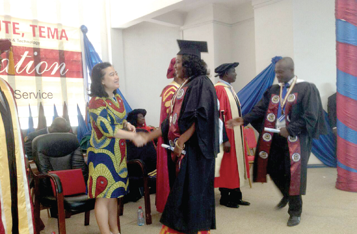  Mrs Christiana Ampomah Nkansah, who graduated with a First Class degree (Human Resource Management Option), in a handshake with the Chinese Ambassador to Ghana, Madam Sun Baohong and other dignitaries at the event.