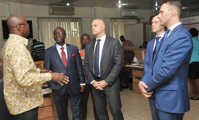 Mr Albert Salia (left), Deputy News Editor of the Daily Graphic, briefing the Crystal TV delegation on the production of the newspapers at the News Room