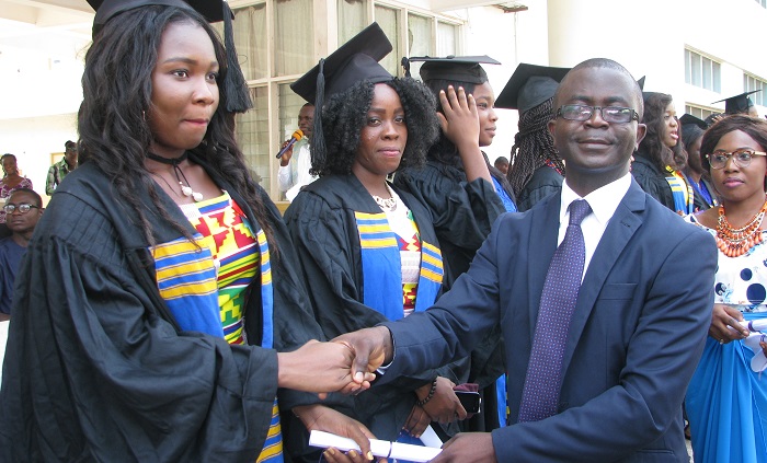 Mr Prince Biney (right), Finance Director of Sahel Sahara Bank and the Director of Health Management College, presenting an award to Abigail Kyei  (left ), SRC President.  Picture: ESTHER ADJEI