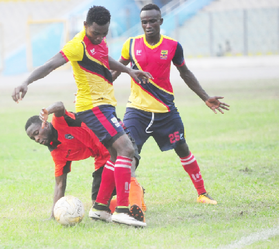 Bechem United’s Hamza Mohammed (down) struggling it out against Hearts  new recruits Anthony Nimo, and defender Patrick Razak.