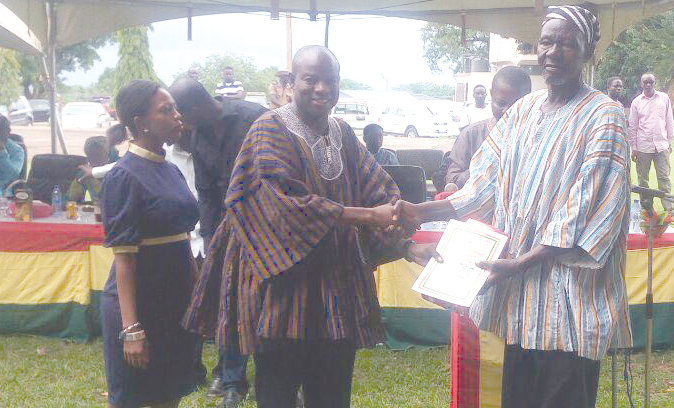 Mr Sa-eed (left) presenting a certificate of honour to one of the senior citizens