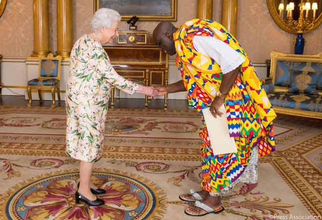 Queen Elizabeth II (left), congratulating Papa Owusu-Ankomah after presenting the letters