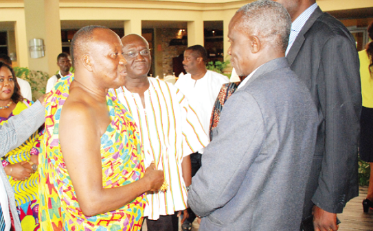 Nana Otuo Siriboe II (middle) and Mr Joseph Kofi Adda (in smock) interacting with some participants