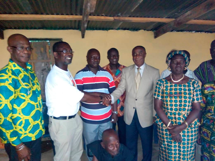 •Mr Kwabeng Bempong (in suit) thanking Dr Adansi Pipim for the gesture. Also in the picture is Nana Kwabena Fori II (middle)