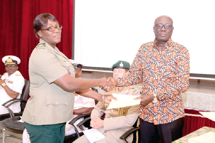 • Mr Duncan Opare presenting a certificate to Supt. Agnes Tingan of the Ghana Immigration Service at the closing ceremony. Picture: EMMANUEL ASAMOAH ADDAI  