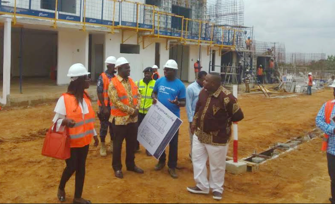 Mr Alan Kyerematen (2nd left) being conducted round the construction site after the symbolic sod cutting