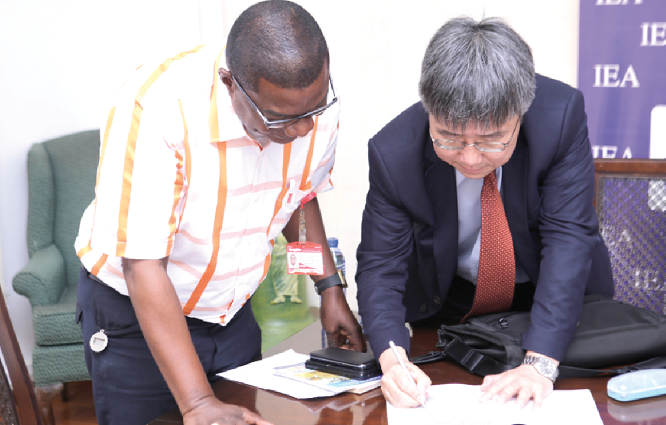 Dr Chang autographing his book on ‘Transformative industrial policy for Africa’ to Mr Kobby Asmah, Political Editor, Daily Graphic, after the interview in Accra yesterday