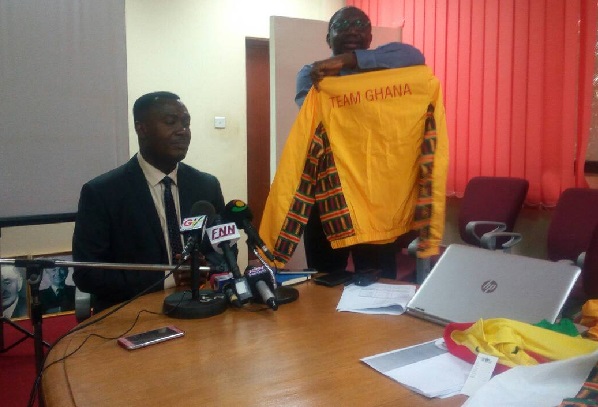The Chef de Mission, Mawuko Afadzinu addressing the press conference while Reverend Richmond Quarcoo displays the Team Ghana kits.