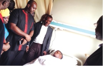 Mr Asiamah (2nd left) at the bedside of Ashitey Ollenu during his visit to KATH 