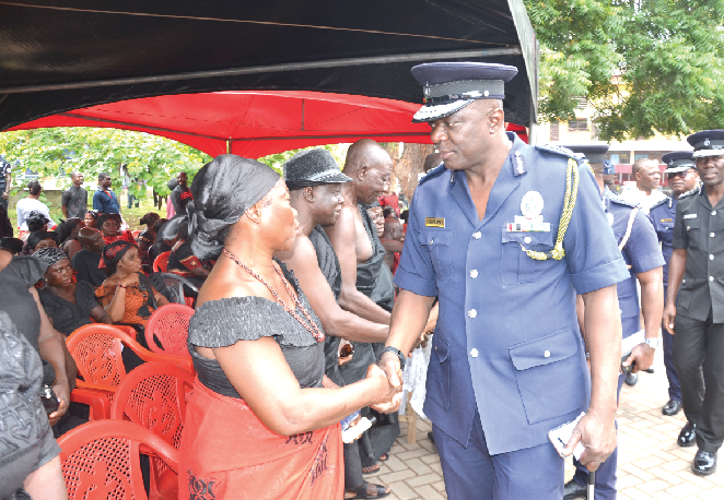 IGP David Asante-Appeatu and other officers of the Ghana Police Service commiserating with family  members at the one-week observance of the death of Constable Daniel Owusu