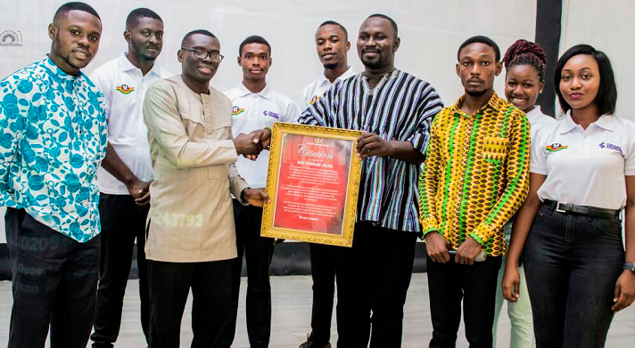 Mr Francis Duah Darko (right, in smock) presenting the citation to Rev. Kwame Adjei. With them are the Kumasi Metro NASPA executive members