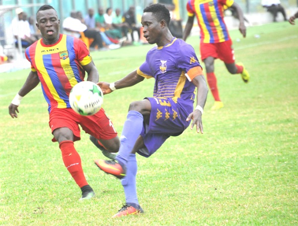 Tema Youth captain Jacob Larweh beats Hearts of Oak forward Patrick Razak to the ball during yesterday’s match. Picture: Ebow Hanson 