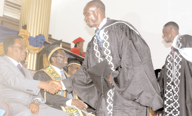 Prof. Kwasi Yankah, the Minister in charge of Tertiary Education, congratulating one of the graduands