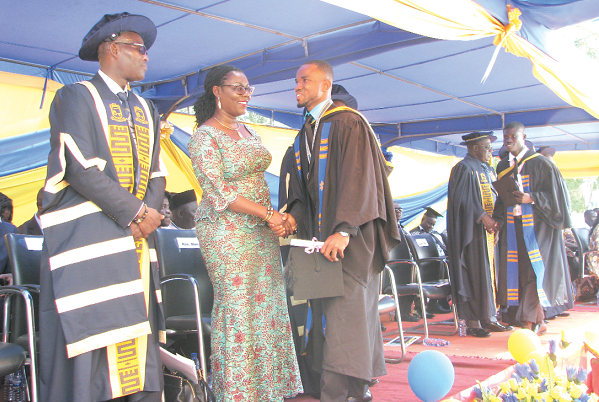  Mrs Ursula Owusu-Ekuful (2nd left) and some officials congratulating some graduates. Picture: ESTHER ADJEI