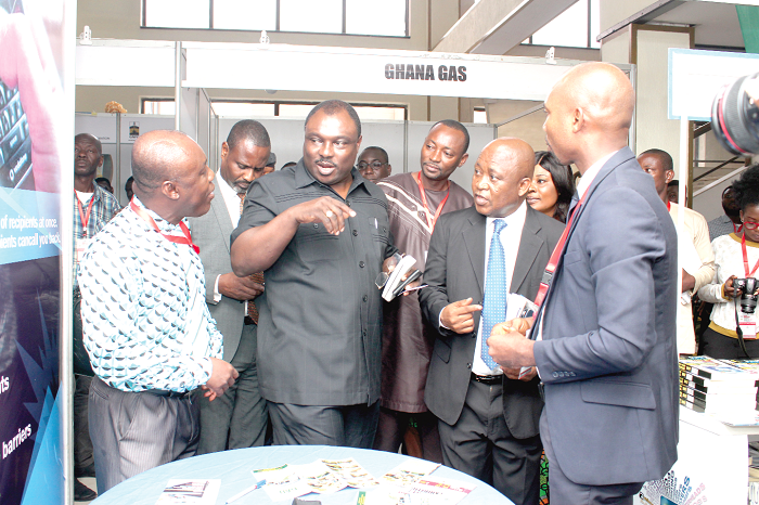   Mr Robert Ahomka-Lindsey (middle), interacting with some participants at an exhibition which formed part of the summit. Picture: BENEDICT OBUOBI