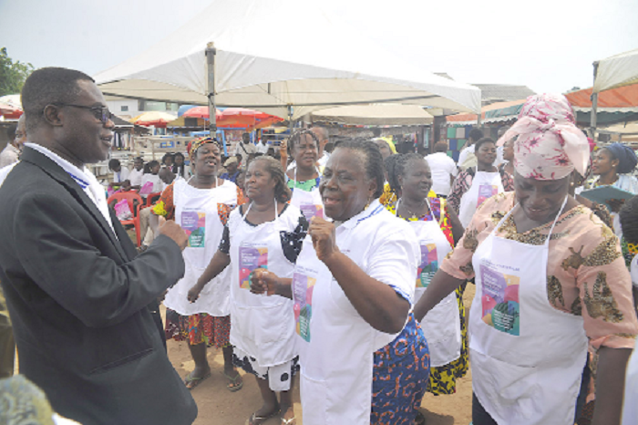 Mr Baah Wadieh (left) dancing with some of the traders at the event 