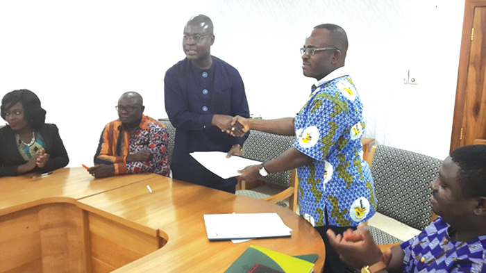 The CEO of the Chamber of Mines, Mr Sulemana Koney (right), exchanging the pact with the Director-General of the Ghana Standards Authority in Accra