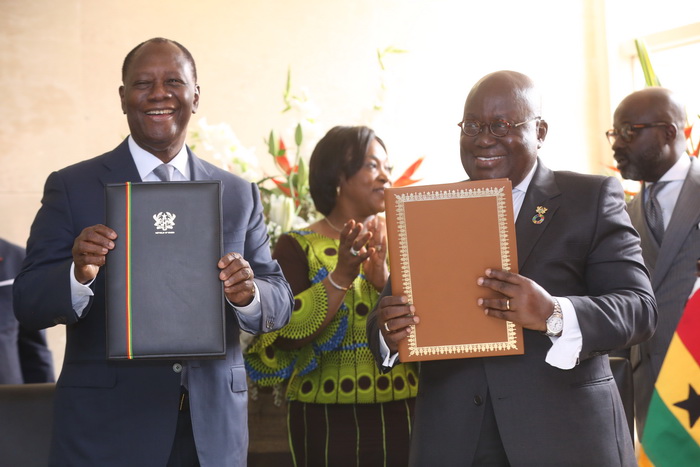 President Akufo-Addo and President Alassane Ouattara (left) displaying documents after signing the ITLOS agreements in Accra.