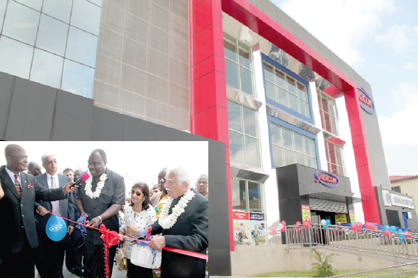 The new Melcom Achimota branch. INSET: Mr Robert Ahomka-Lindsay (3rd left), the Deputy Minister of Trade and Industry, and Mr Bhagwan Khubchandani (right), Melcom Group Chairman, cutting a tape to officially open the Melcom Achimota branch. Looking on are some dignitaries. Pictures: EDNA ADU-SERWAA
