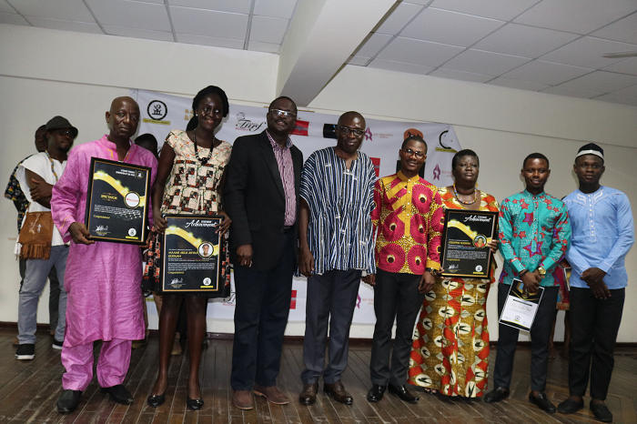 The four award winners in a group photograph with the dignitaries at the awards ceremony