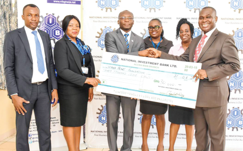 Mr Charles Wordey (3rd left) presenting the cheque to Dr Agyemang Sereboe (right), while officials of the bank and the National Cardiothoracic Centre look on