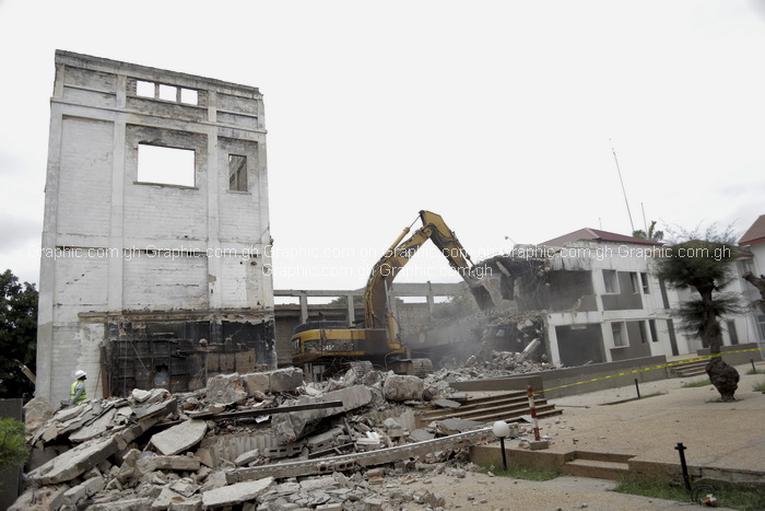 An excavator in the process of pulling down the Old Parliament House in Accra.