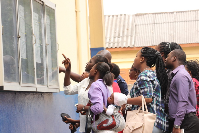 Some parents checking the names of their children on the notice board at the St Mary's Senior High School