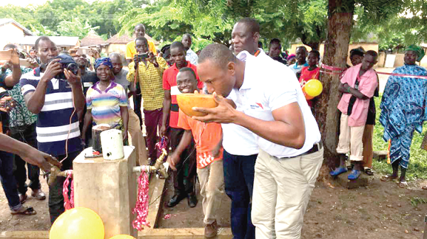  LEFT: The sanitation equipment. RIGHT: Mr Timothy A. Amang-bey Akanpabadai taking a sip after handing over the borehole to the community.