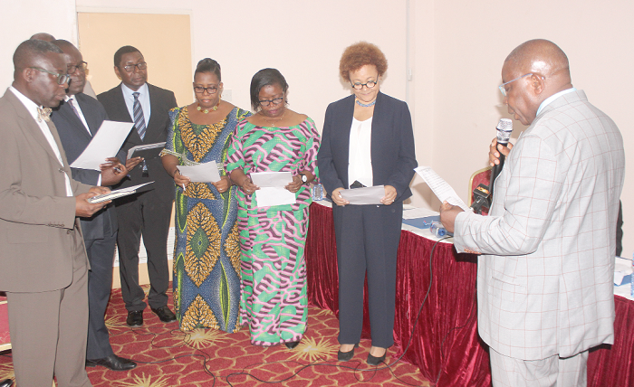 Mr Kweku Agyeman Manu (right), Minister of Health, administering the oath of office to the Psychology Council Board. 