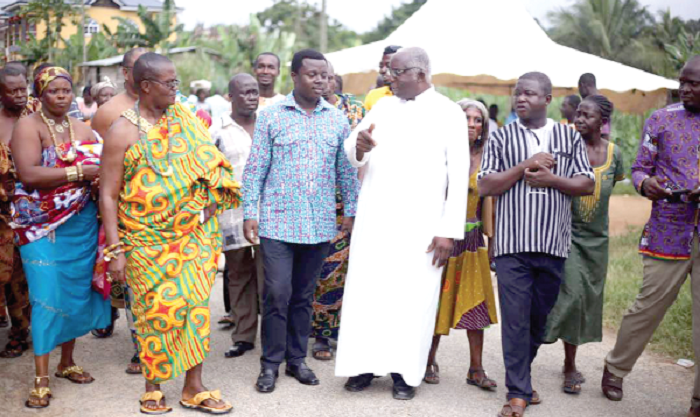 Rev John Ntim Fordjour, MP for Assin South (middle), holding discussions with elders and traditional rulers of the community after a sod was cut for the commencement of the project