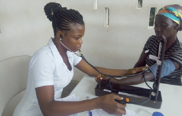 A nurse checking the the vital health statistics of a patient