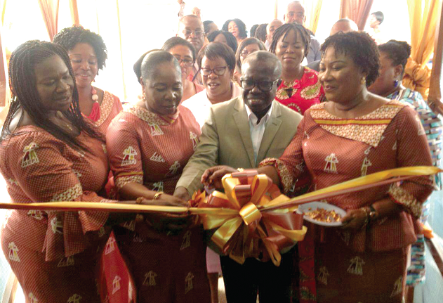 From left to right: Mrs Abi Kyeremanteng and Mrs Sonia Antwi assisting Dr Kwabena Opoku-Adusei to cut the tape to officially inaugurate the renovated female medical ward.