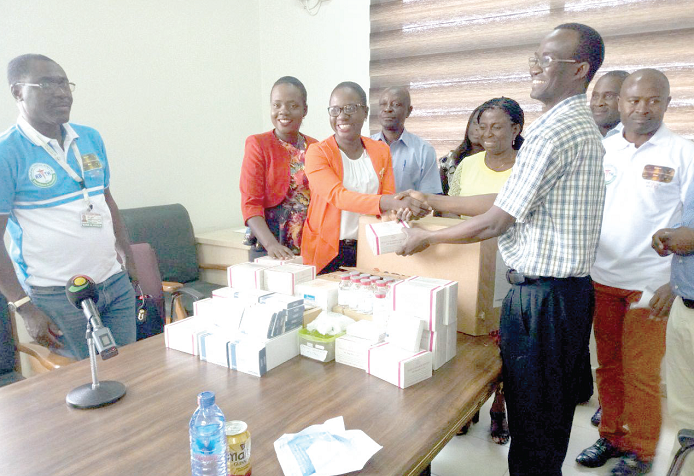 Dr Dzifa Anyah-Nani and Dr Emefa Anyah-Lartey, Daughters of the chief executive officer of the Korle Bu Teaching Hospital presenting the essential medicines to an official of the hospital