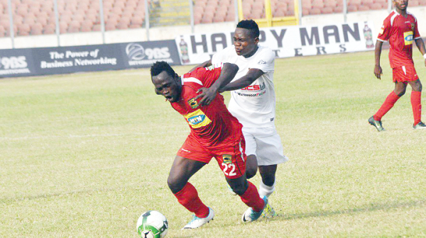 Kotoko’s Yakubu Mohammed is being prevented by his Dreams FC opponent from reaching the ball.