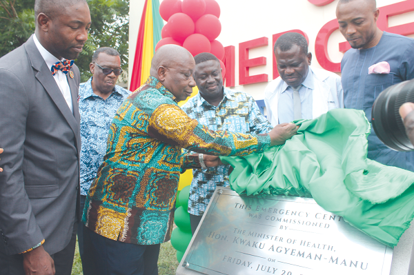   million. Kwaku Agyeman-Manu unveils a plaque for the opening of the new Emergency and Accident Center. With him, Dr. Samuel Asiamah, interim CEO, and some heads of departments of the hospital. Photo: Gabriel Ahiabor 