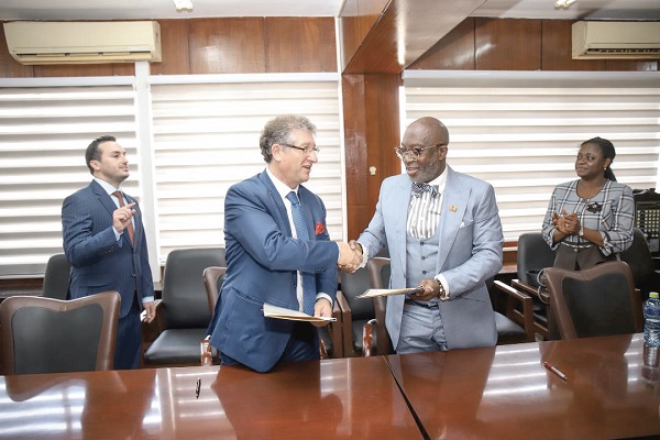 Mr. Michael Grech (left) exchanging the agreement with Mr. Yofi Grant