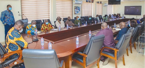 Dr Yaw Adutwum (seated left) in a meeting with the committee members