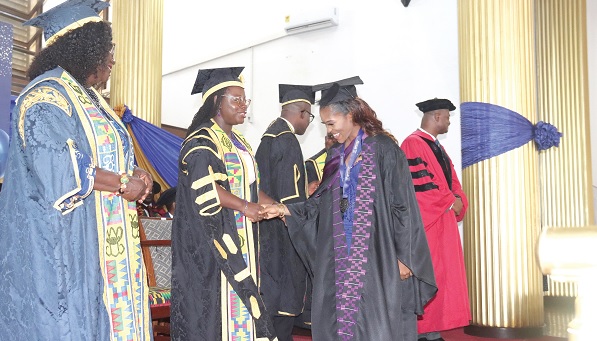 Prof. Nana Aba Appiah Amfo (2nd from left), Vice-Chancellor, University of Ghana, Legon, congratulating Abigail Nakuor Wowolo (right), Valedictorian, after receiving her medal. Looking on is Doris Kisiwa Ansa (left), a member of the University Council. Picture: ELVIS NII NOI DOWUONA