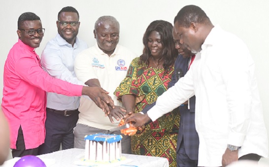 Yaw Frimpong Addo (2nd from right), Deputy Minister of Food and Agriculture (Crops), being assisted by Ernestina Osei-Tutu (3rd from right), Chairperson of the Association, and some dignitaries to cut a cake to inaugurate the Ghana Association of Female Agriculture and Fish Farming Award Winners in Accra last Thursday